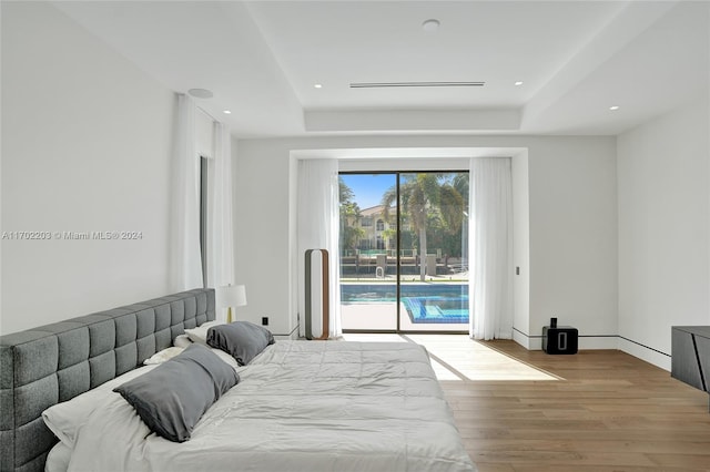 bedroom with access to outside and light hardwood / wood-style floors