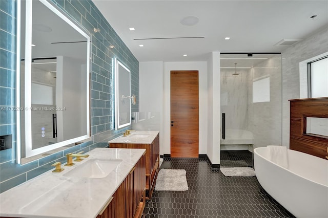 bathroom featuring vanity, separate shower and tub, and tile walls