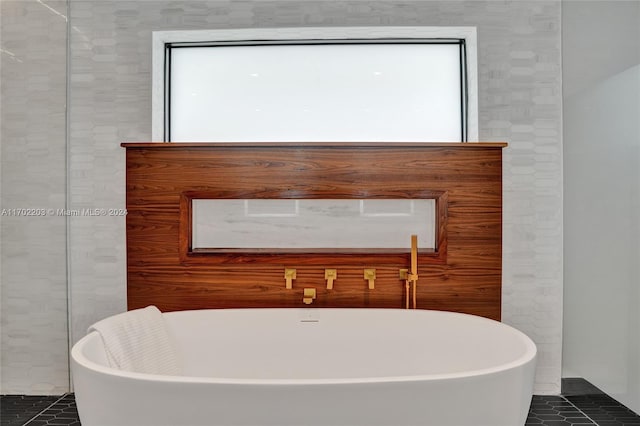 bathroom featuring tile patterned flooring and a bathtub