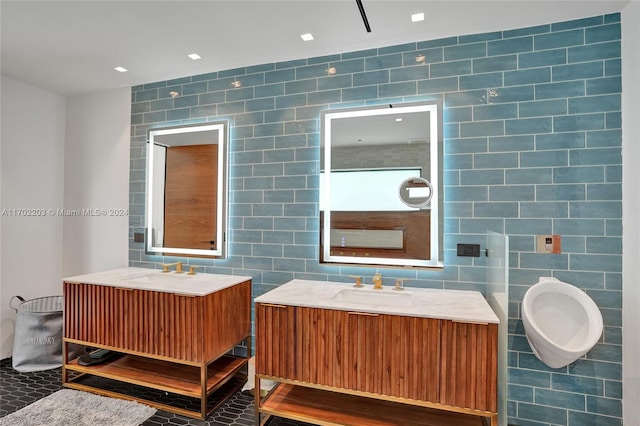 bathroom featuring tile patterned flooring, vanity, and tile walls