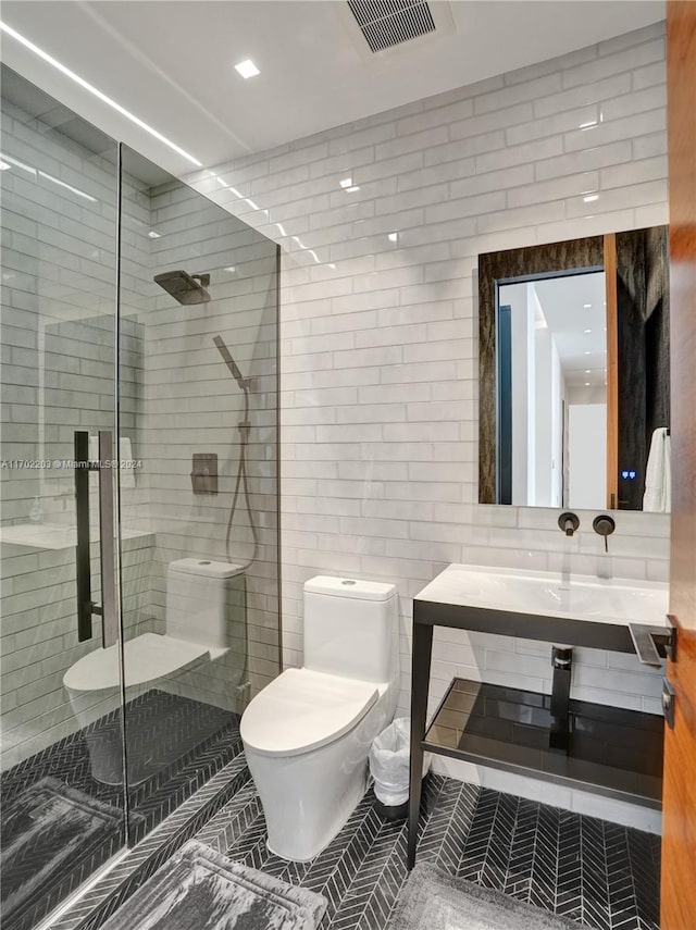 bathroom with vanity, tile patterned floors, toilet, walk in shower, and tile walls