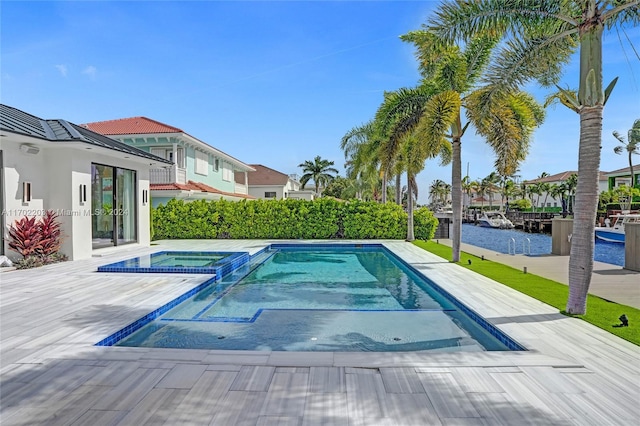 view of swimming pool featuring an in ground hot tub and a water view