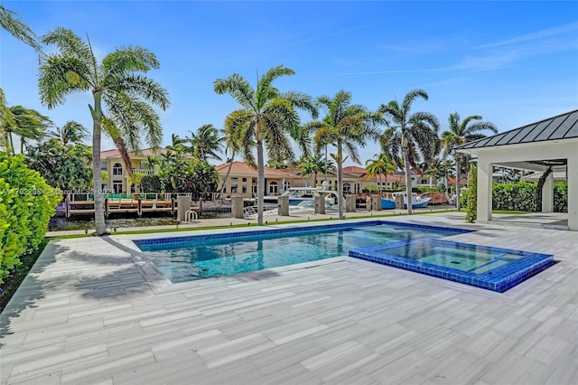 view of pool featuring an in ground hot tub and a patio area