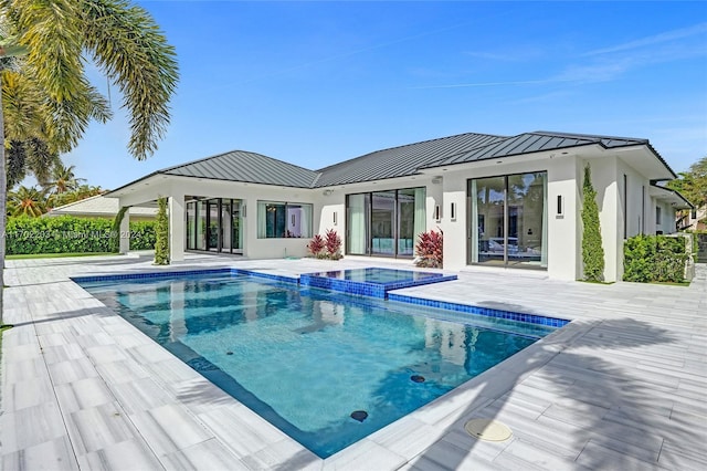 view of swimming pool with an in ground hot tub and a patio area