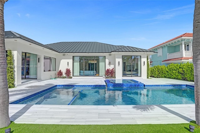 view of swimming pool featuring a patio area and an in ground hot tub