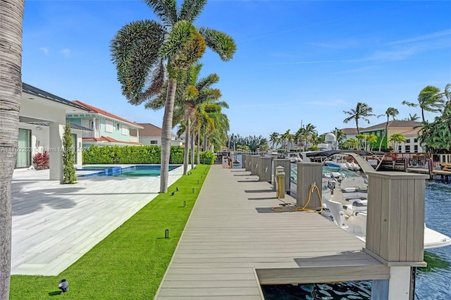 view of dock featuring a yard and a water view