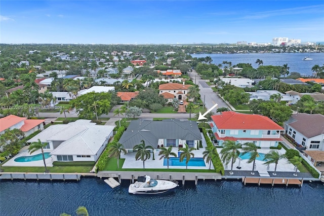 birds eye view of property with a water view