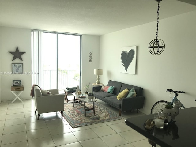 living room with light tile patterned floors and a wall of windows