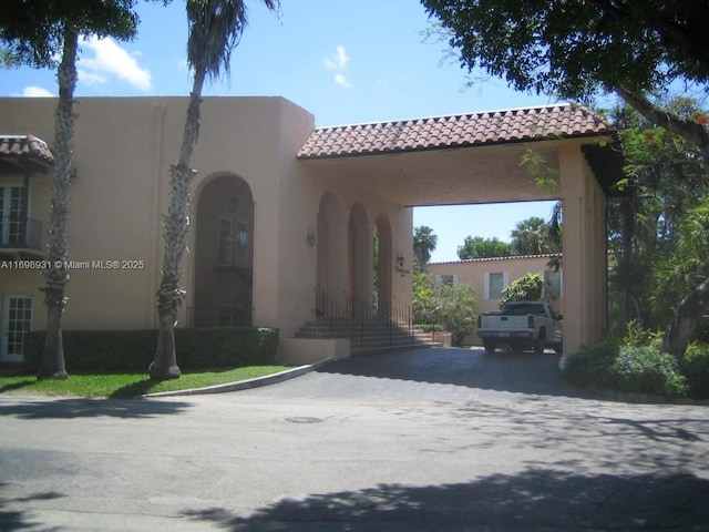10806 N Kendall Dr Unit P-26, Miami, FL 33176 - view of front facade featuring a tiled roof and stucco siding