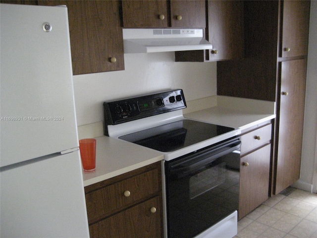 kitchen with dark brown cabinetry and white appliances