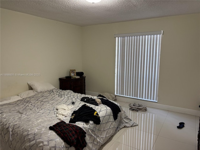 10806 N Kendall Dr Unit P-26, Miami, FL 33176 - bedroom with tile patterned flooring, multiple windows, baseboards, and a textured ceiling