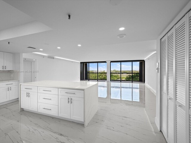 kitchen featuring white cabinets, sink, a kitchen island, and appliances with stainless steel finishes