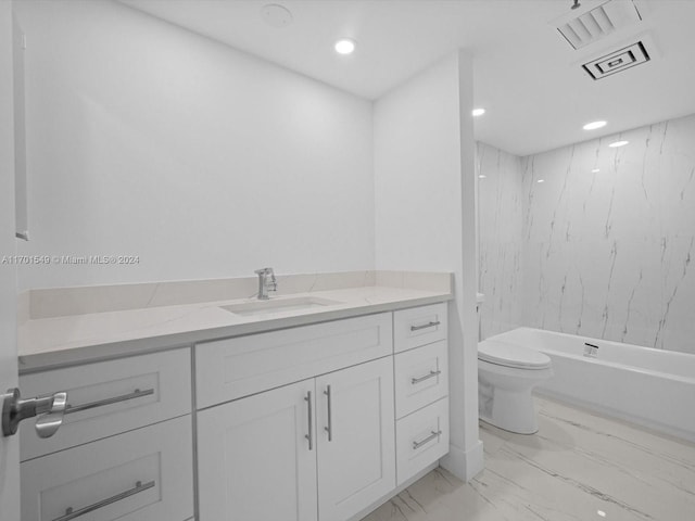 full bathroom featuring tiled shower / bath, vanity, and toilet