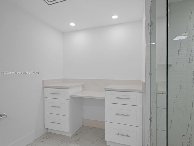 bathroom with vanity and a tile shower