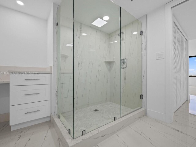 bathroom featuring a shower with door