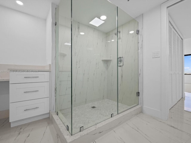 full bath with a closet, marble finish floor, and a marble finish shower