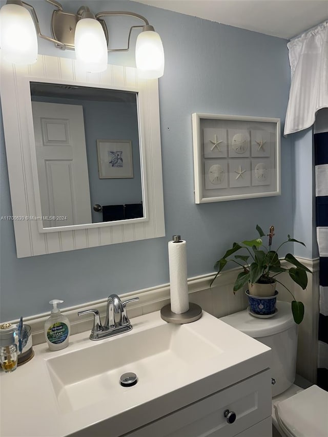 bathroom featuring vanity and toilet