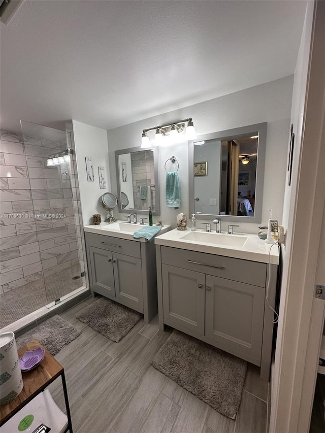 bathroom with a tile shower, hardwood / wood-style floors, and vanity