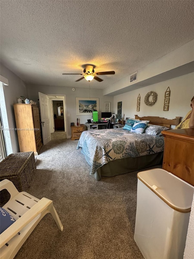 carpeted bedroom with ceiling fan and a textured ceiling