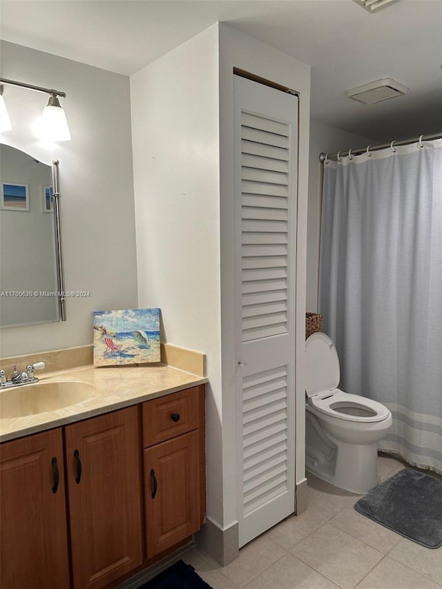 bathroom featuring tile patterned flooring, vanity, and toilet