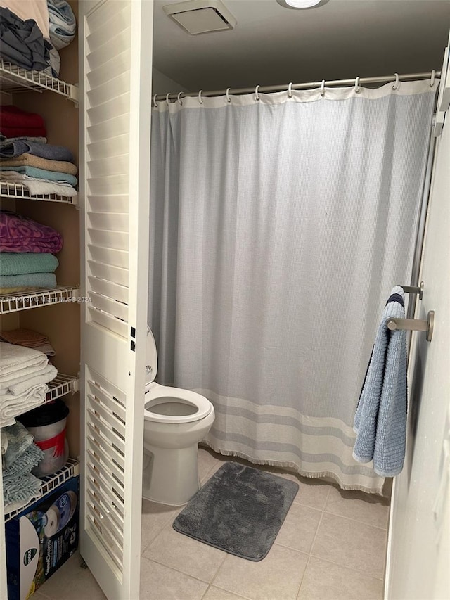 bathroom featuring tile patterned flooring and toilet