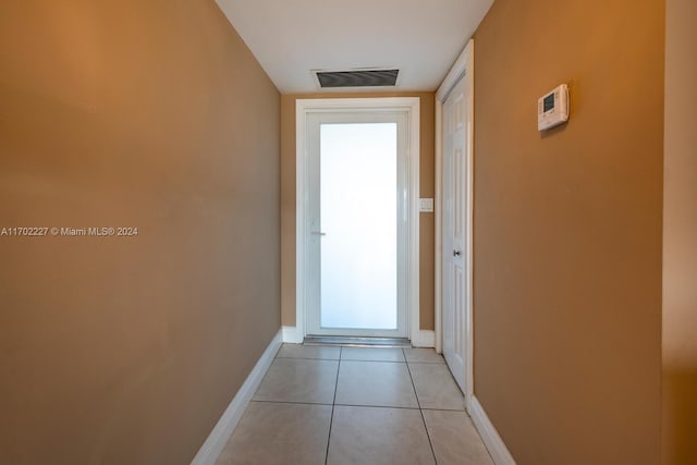 corridor with light tile patterned flooring