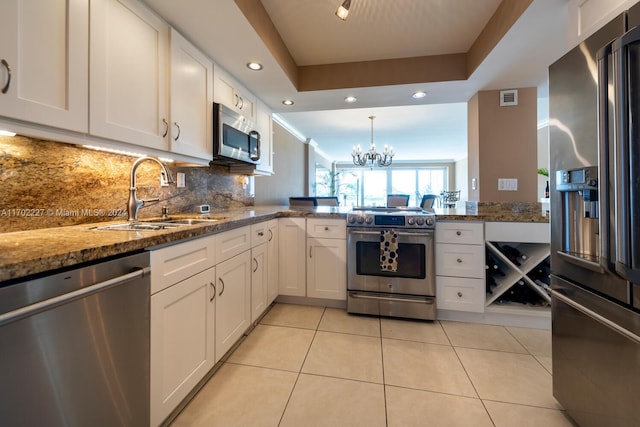 kitchen featuring white cabinets, stone countertops, sink, and appliances with stainless steel finishes