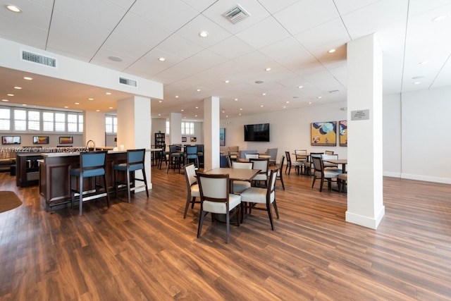 dining space with dark hardwood / wood-style flooring and sink