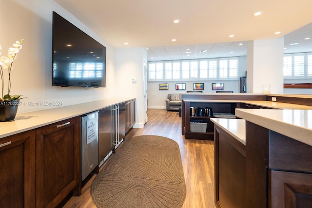 kitchen with plenty of natural light, dishwasher, and light hardwood / wood-style flooring