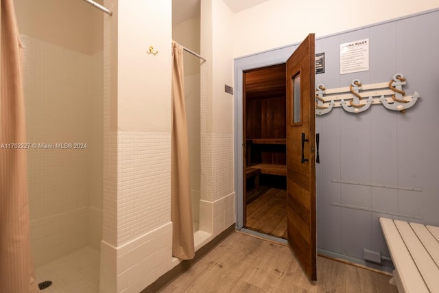 bathroom with a shower with shower curtain and wood-type flooring