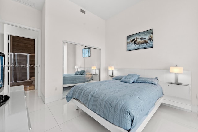 bedroom featuring a closet and light tile patterned flooring