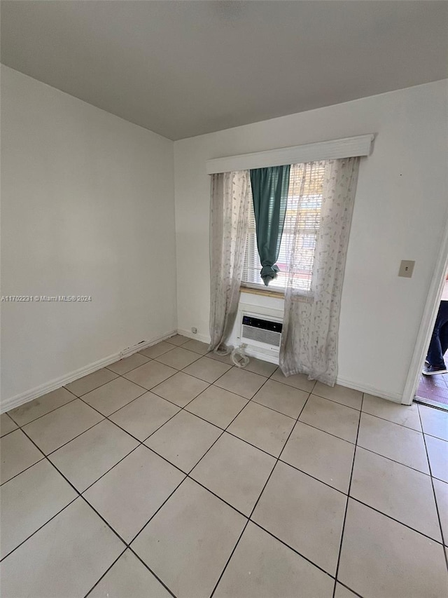 tiled spare room with a wall mounted AC