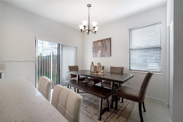 dining room featuring a notable chandelier and light tile patterned flooring