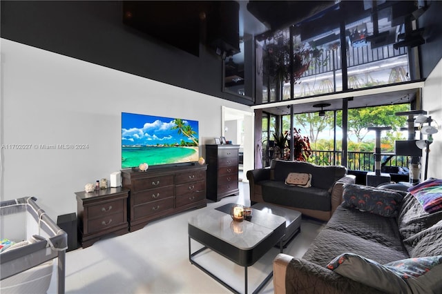 living room featuring a towering ceiling