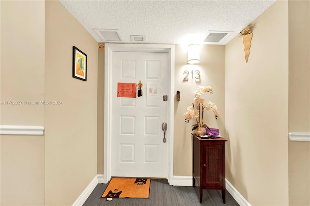 entrance foyer featuring a textured ceiling