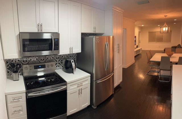 kitchen with stainless steel appliances, white cabinets, and dark wood-style flooring