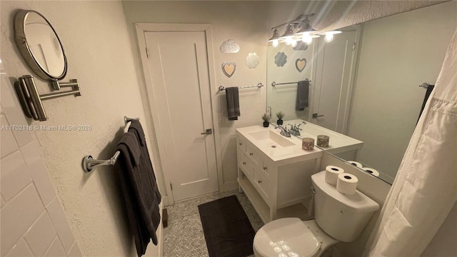 bathroom featuring toilet and vanity