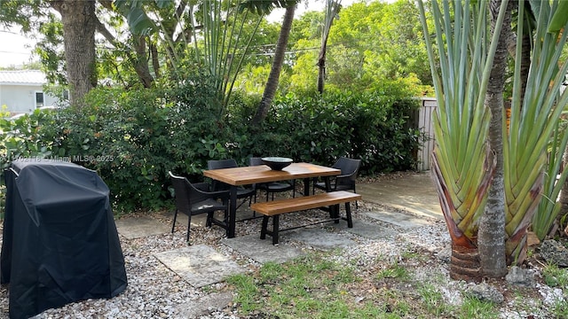 view of patio / terrace with area for grilling, outdoor dining space, and fence