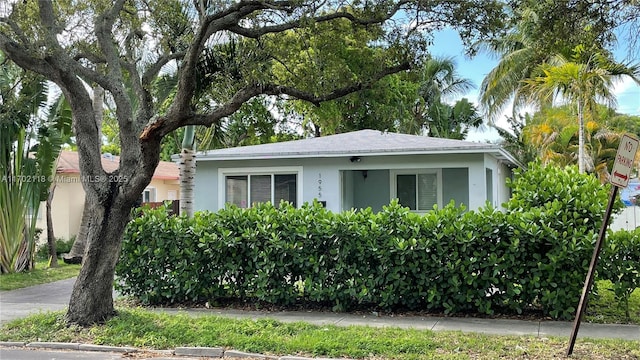 bungalow-style home with stucco siding