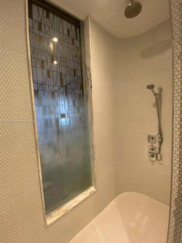 bathroom with a tile shower