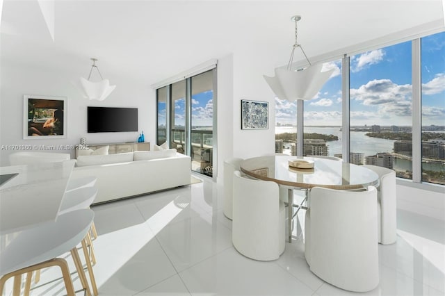 dining area featuring light tile patterned floors and floor to ceiling windows