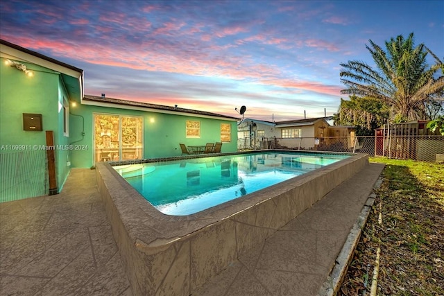 view of pool at dusk