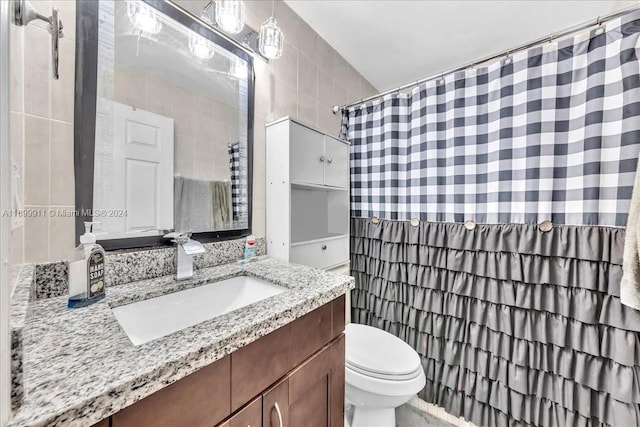 bathroom featuring vanity, toilet, and walk in shower