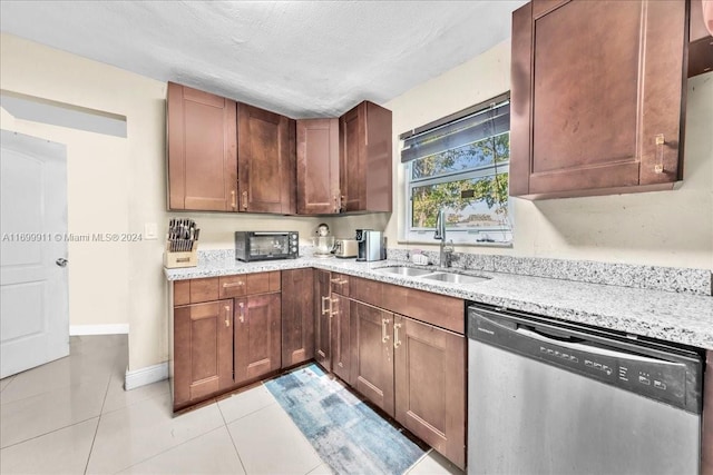 kitchen featuring light stone counters, a textured ceiling, sink, light tile patterned floors, and dishwasher