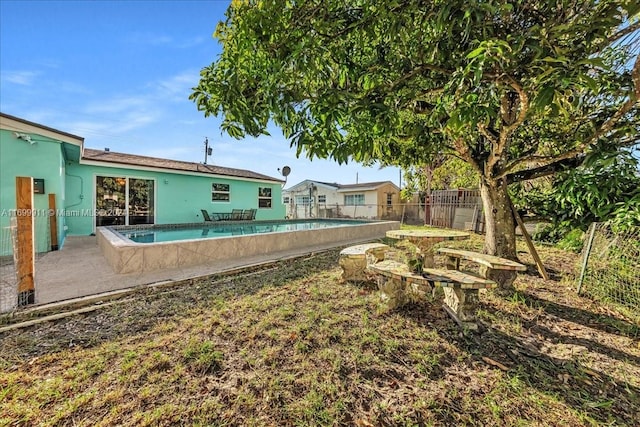 view of yard with a fenced in pool and a patio area