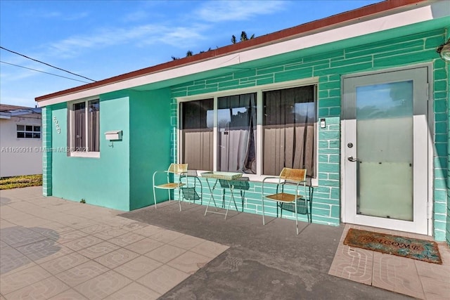 entrance to property with a patio