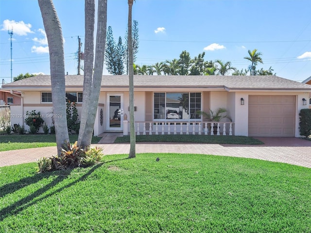 single story home with a porch, a garage, and a front lawn