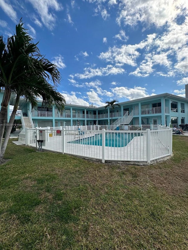 view of swimming pool featuring a patio area and a lawn