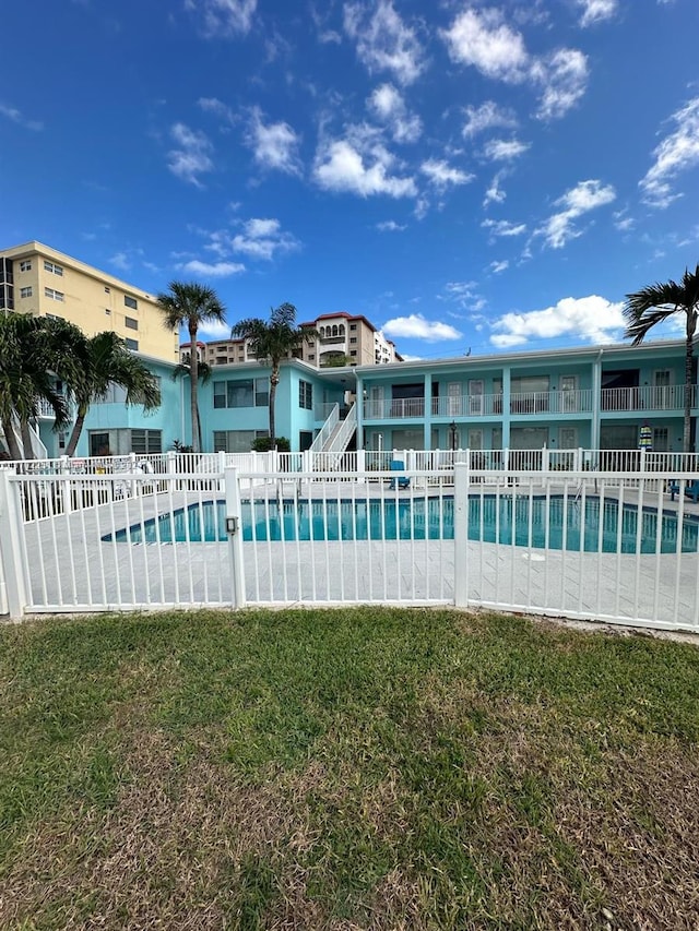 view of swimming pool featuring a yard and a patio