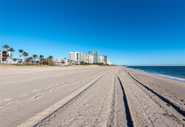 view of street featuring a water view and a beach view